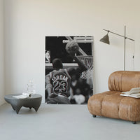 Basketball player dunking with NBA logo visible poster framed in a luxury living-room setting