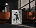 Black-framed Michael Jordan slam dunk print on a moody console with designer coffee-table books