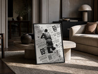 Michael Jordan slam dunk print in a black frame leaning on a travertine table in a sunlit lounge