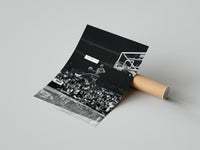 Hands unrolling a Michael Jordan free throw dunk art print on a polished concrete surface revealing the basketball legend