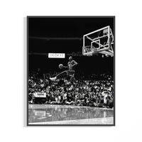 Michael Jordan in midair performing a free throw line slam dunk in dramatic black and white poster photography