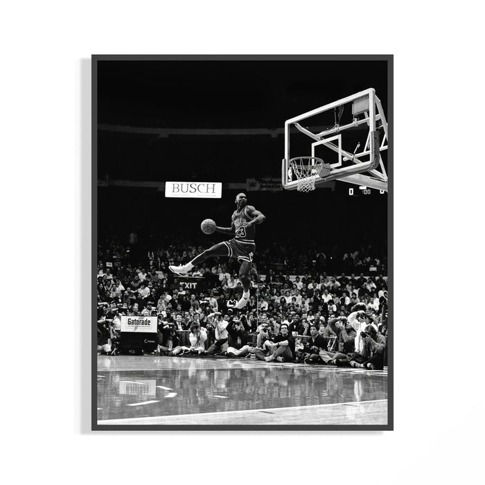 Michael Jordan in midair performing a free throw line slam dunk in dramatic black and white poster photography