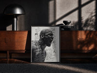 Black-framed Michael Jordan screaming portrait print on a moody console with designer coffee-table books