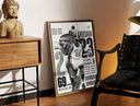 Brass-framed Michael Jordan basketball player print leaning in a warm styled corner by a sculpture