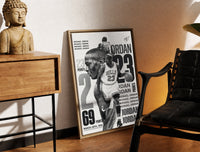 Brass-framed Michael Jordan basketball player print leaning in a warm styled corner by a sculpture