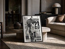 Michael Jordan basketball player print in a black frame leaning on a travertine table in a sunlit lounge
