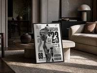 Michael Jordan basketball player print in a black frame leaning on a travertine table in a sunlit lounge