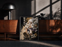 Black-framed Laughing white-haired anime warrior print on a moody console with designer coffee-table books