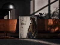 Black-framed Anime pirate in straw hat print on a moody console with designer coffee-table books