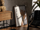Walnut-framed White-haired smiling anime man profile print leaning against a sunlit rustic brick wall