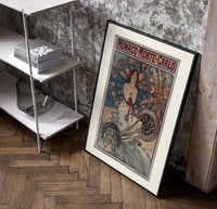 Art Nouveau woman with flowers poster in a black frame leaning beside a shelf in a raw-plaster loft