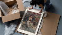 Art Nouveau woman with flowers framed print being unpacked from protective bubble wrap and a box