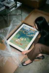 The Moomins playing under autumn tree with falling leaves poster shown across its range of print sizes