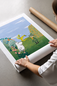 Moomin character with child in magical garden landscape print laid flat in a styling flatlay