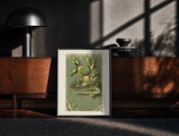 Black-framed Church A Merry Christmas print on the floor in front of a dark wooden console