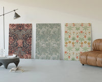 Victorian floral wallpaper patterns triptych three-panel set displayed beside a brown leather sofa