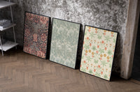 Victorian floral wallpaper patterns triptych set of three black-framed prints leaning against a raw-plaster wall