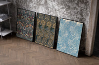 William Morris floral bird patterns set of three black-framed prints leaning against a raw-plaster wall
