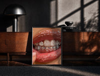 Black-framed Mouth with Heart Tooth Gems print on the floor in front of a dark wooden console