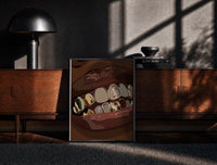 Black-framed Mouth with Jeweled Gold Grillz print on the floor in front of a dark wooden console