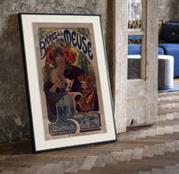 Woman drinking beer with poppies print in a black frame leaning beside a vintage door on parquet