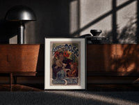 Black-framed Woman drinking beer with poppies print on a moody console with designer coffee-table books