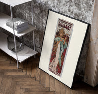 Woman holding champagne glass poster in a black frame leaning beside a shelf in a raw-plaster loft