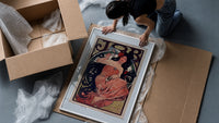 Woman with flowing dark hair smoking framed print being unpacked from protective bubble wrap and a box