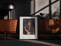 Black-framed Woman with flowing hair smoking print on a moody console with designer coffee-table books