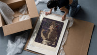 Woman with flowing hair smoking framed print being unpacked from protective bubble wrap and a box
