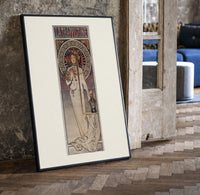 Art Nouveau woman with flowers print in a black frame leaning beside a vintage door on parquet