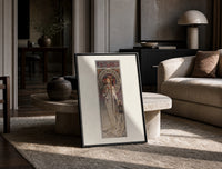 Art Nouveau woman with flowers print in a black frame leaning on a travertine table in a sunlit lounge