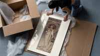 Art Nouveau woman with flowers framed print being unpacked from protective bubble wrap and a box