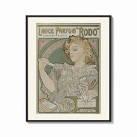 Framed Art Nouveau woman spraying perfume print shown as a bold statement piece on a clean gallery wall