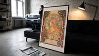 Woman in profile with zodiac halo print in a slim black frame leaning on a dark sofa in a concrete print studio