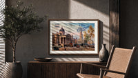 London National Gallery vintage cityscape print in a wood frame above a fluted sideboard beside an olive tree