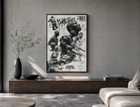 NBA basketball legends collage poster framed above a wood console in a concrete-wall living room