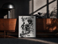 Black-framed NBA basketball legends collage print on a moody console with designer coffee-table books