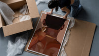 Neckline Trim with Clippers framed print being unpacked from protective bubble wrap and a box
