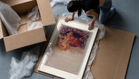 Woman with cymbals and mandolin player framed print being unpacked from protective bubble wrap and a box