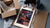 Two elegant women with red parasol framed print being unpacked from protective bubble wrap and a box