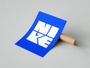 Nike wordmark logo with swoosh graphic poster styled above furniture in a modern room