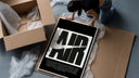 Nike Air logo with swoosh framed print being unpacked from protective bubble wrap and a box