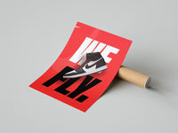 Red Air Jordan 1 We Fly print displayed on a wall showing the white Nike logo, black swoosh and sneaker image