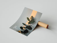 Nike botanical rubber plant print with warm orange light streak and YOU DO IT text unrolled beside a cardboard tube