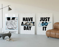 Nike "Have a Nice Day" Sneaker Poster Set of 3 displayed beside a brown leather sofa