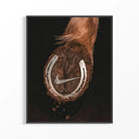 Nike Horse Hoof Swoosh artwork in black frame showing horse's hoof with Nike swoosh and horseshoe against dark.