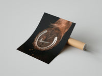 Woman unrolling a Nike Horse Hoof Swoosh poster on a concrete floor revealing the surreal swoosh photo