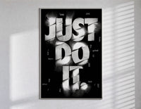Just Do It typography design poster in a slim frame on a bright wall with soft window light