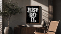 Just Do It typography design poster framed above a fluted sideboard beside an olive tree